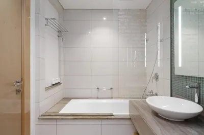 a white bathroom with a tub and a sink at HSHOME - Luxury 3 Bedroom Apartment with Burj Khalifa & Stunning Skyline View in Dubai