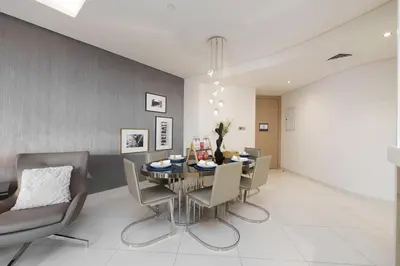 a dining room with a table and chairs at HSHOME - Luxury 3 Bedroom Apartment with Burj Khalifa & Stunning Skyline View in Dubai