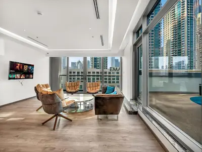 a living room with chairs and a table and large windows at Large modern STUDIO in STERLING DOWNTOWN I DUBAI MALL I Sleeps 4 I Amazing Balcony in Dubai
