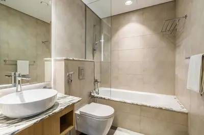 a bathroom with a sink and a toilet and a tub at RH - Luxury 2BR at Paramount Midtown, Burj Khalifa View in Dubai