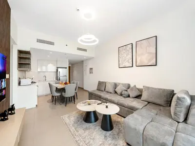 a living room with a couch and a table at Downtown Dubai 1BR Apartment I Balcony I Dubai Mall Access in Dubai