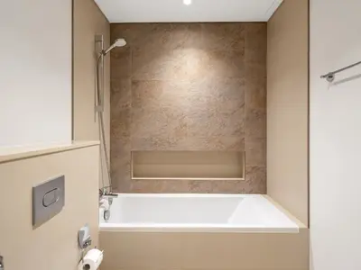 a bathroom with a bath tub and a shower at Downtown Dubai 1BR Apartment I Balcony I Dubai Mall Access in Dubai