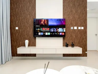 a flat screen tv on a wall in a room at Downtown Dubai 1BR Apartment I Balcony I Dubai Mall Access in Dubai