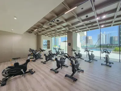 a gym with treadmills and exercise bikes in a room at Luxury 1BR - Binghatti Phantom - Amazing Amenities in Dubai