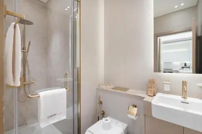 a bathroom with a toilet and a sink and a shower at Luxury 1BR - Binghatti Phantom - Amazing Amenities in Dubai