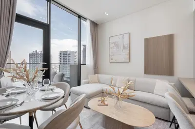 a living room with a couch and a table at Luxury 1BR - Binghatti Phantom - Amazing Amenities in Dubai
