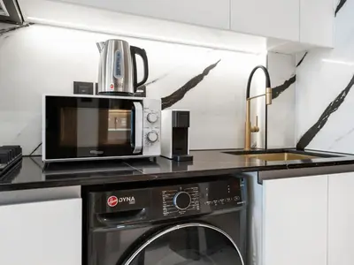 a microwave sitting on top of a kitchen counter at Luxury Studio with Private Jacuzzi & Balcony Trillionaire Residences 4 Guests in Dubai