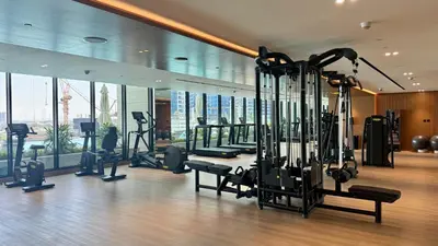 a gym with treadmills and exercise equipment in a building at Luxury Studio with Private Jacuzzi & Balcony Trillionaire Residences 4 Guests in Dubai
