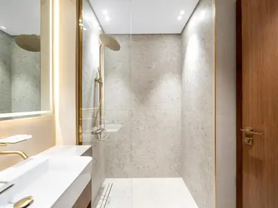 a bathroom with a shower and a sink at Luxury Studio with Private Jacuzzi & Balcony Trillionaire Residences 4 Guests in Dubai