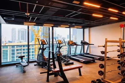 a gym with several tread machines and a large window at Near World Trade Center Sleeps 5 Family Business Friendly in Dubai