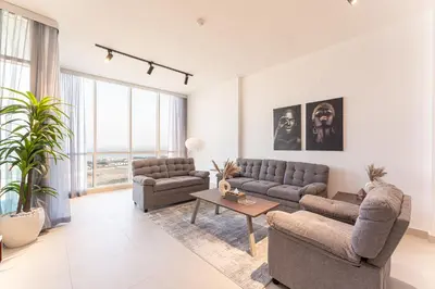 a living room with two couches and a table at HAVN - 2 bed in Hilliana Tower, Jumeirah Burj View in Dubai