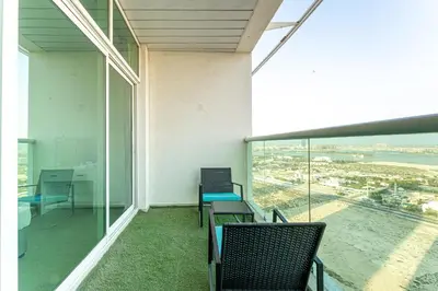 an empty room with chairs and a view of the ocean at HAVN - 2 bed in Hilliana Tower, Jumeirah Burj View in Dubai