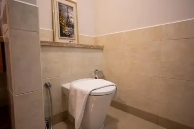 a bathroom with a toilet with a towel on it at Luxury 2BR Haven with Panoramic Scenery - The Greens in Dubai