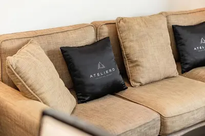 a brown couch with two black pillows on it at JW Marriott Marina Apartments in Dubai