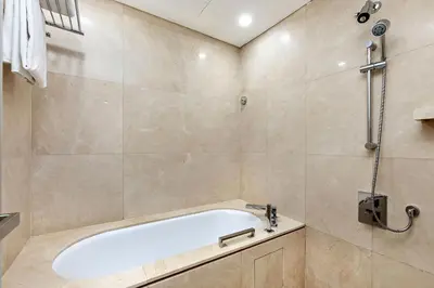 a bathroom with a bath tub and a shower at JW Marriott Marina Apartments in Dubai