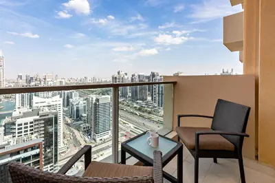 a balcony with two chairs and a table with a view at JW Marriott Marina Apartments in Dubai