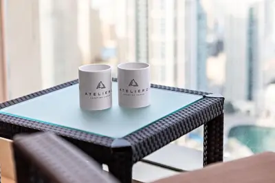 two white cups sitting on a table in front of a window at JW Marriott Marina Apartments in Dubai