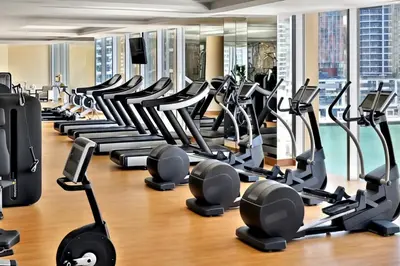 a gym with a lot of tread machines at JW Marriott Marina Apartments in Dubai