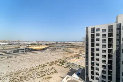 an aerial view of a building and a beach at Modern & Cozy 2BR Apartment at The Nook 1 Near Metro in Dubai