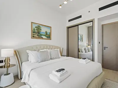 a bedroom with a large white bed with a tray on it at Charming 2BDR Stay in Binghatti Corner- JVC in Dubai