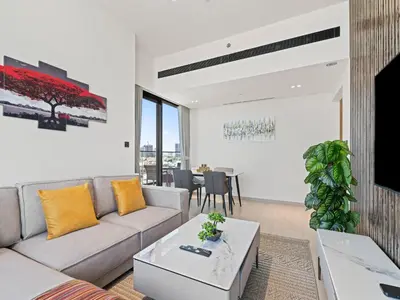 a living room with a couch and a table at Charming 2BDR Stay in Binghatti Corner- JVC in Dubai