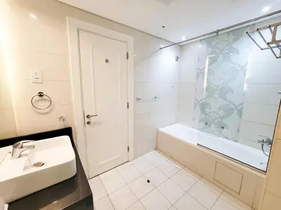 a bathroom with a sink and a tub and a shower at DAMAC CAPITAL BAY - Blueocean Holiday Homes in Dubai