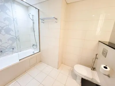 a bathroom with a shower and a toilet at DAMAC CAPITAL BAY - Blueocean Holiday Homes in Dubai