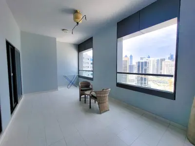 a room with a window and a table and chairs at DAMAC CAPITAL BAY - Blueocean Holiday Homes in Dubai