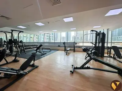 a gym with a bunch of treadmills and machines at Vogue JLT Global Lake View Tower near Marina and JBR, Two Bedroom Apartment with Balcony and City view, Access to all Amenities in Dubai