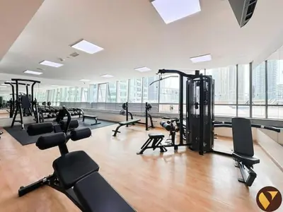 a gym with a lot of treadmills and exercise bikes at Vogue JLT Global Lake View Tower near Marina and JBR, Two Bedroom Apartment with Balcony and City view, Access to all Amenities in Dubai
