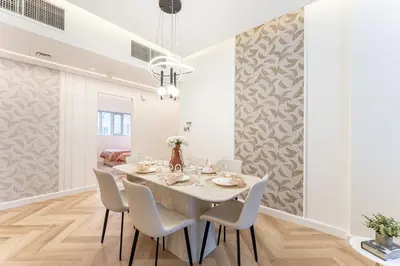 a dining room with a white table and chairs at HAVN- 3 bedroom in DAMAC Majestine, Business Bay in Dubai