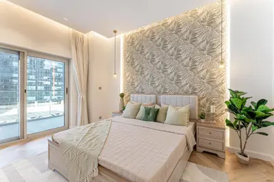 a bedroom with a bed and a large window at HAVN- 3 bedroom in DAMAC Majestine, Business Bay in Dubai