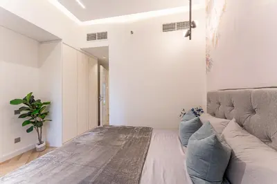 a bedroom with a bed and a couch at HAVN- 3 bedroom in DAMAC Majestine, Business Bay in Dubai