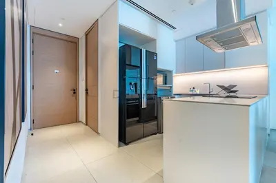 a kitchen with a counter top and a refrigerator at Sea View, Direct Beach Access - The Address Residences, JBR by Deluxe Holiday Homes in Dubai