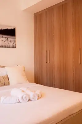 a bedroom with a bed with towels on it at Large Beautiful One Bed Downtown Dubai in Dubai