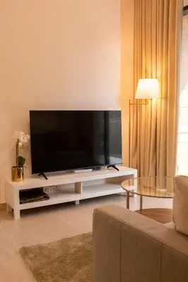a living room with a large flat screen tv at Large Beautiful One Bed Downtown Dubai in Dubai
