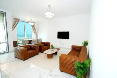 a living room with two couches and a tv at Skyline & Islands View 3BR Luxe Top Floor Noura Tower Business Bay in Dubai