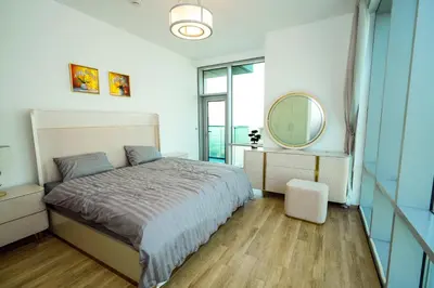 a bedroom with a large bed and a mirror at Skyline & Islands View 3BR Luxe Top Floor Noura Tower Business Bay in Dubai