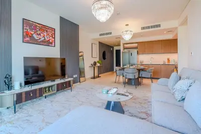 a living room with a couch and a tv at TRPS - Burj Crown, Downtown - Skyline and Pool View, Furnished, Downtown in Dubai