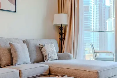 a living room with a couch and a window at TRPS - Burj Crown, Downtown - Skyline and Pool View, Furnished, Downtown in Dubai