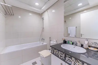 a bathroom with a sink and a tub and a toilet at HAVN- High floor 1 bedroom in Business Bay in Dubai