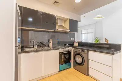 a kitchen with a sink and a washing machine at HAVN- High floor 1 bedroom in Business Bay in Dubai