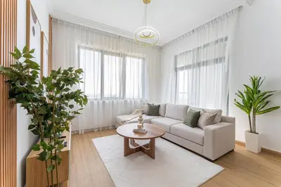 a living room with a couch and a table at HAVN- High floor 1 bedroom in Business Bay in Dubai