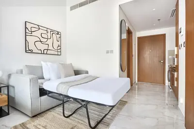 a living room with a couch and a table at Frank Porter - Azizi Beach Oasis in Dubai