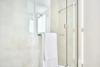 a bathroom with a shower with a glass door at Frank Porter - Al Jazi in Dubai
