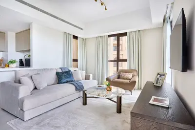 a living room with a couch and a table at Frank Porter - Al Jazi in Dubai