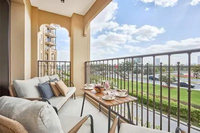 a balcony with a couch and a table at Frank Porter - Al Jazi in Dubai