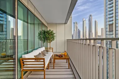 a balcony with a couch and a table at 4BR - Stunning Burj View - Dubai Mall Access in Dubai