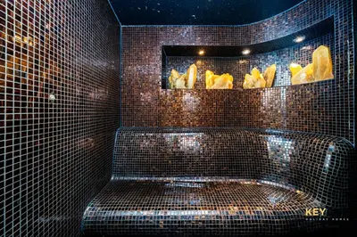 a bathroom with a tub in a tiled wall at The Cosmopolitan Spacious Studio in Dubai
