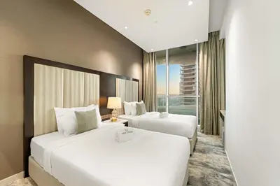 a hotel room with two beds and a window at FIRST CLASS 2BR Vibrant Next to Dubai Mall in Dubai